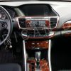 The interior of a car with a wood trim and an accessories for car.