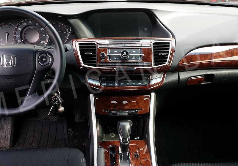 The interior of a car with a wood trim and an accessories for car.