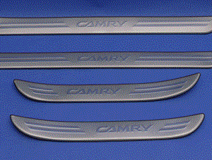 A set of Compatible with Toyota Camry 2002 - 2006 Door Sills on a blue surface, featuring a wood dash kit.
