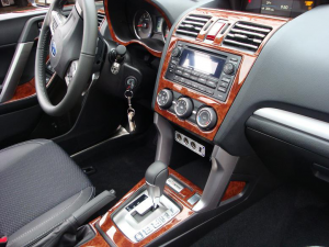 The interior of a car with a Wood dash kit and steering wheel.